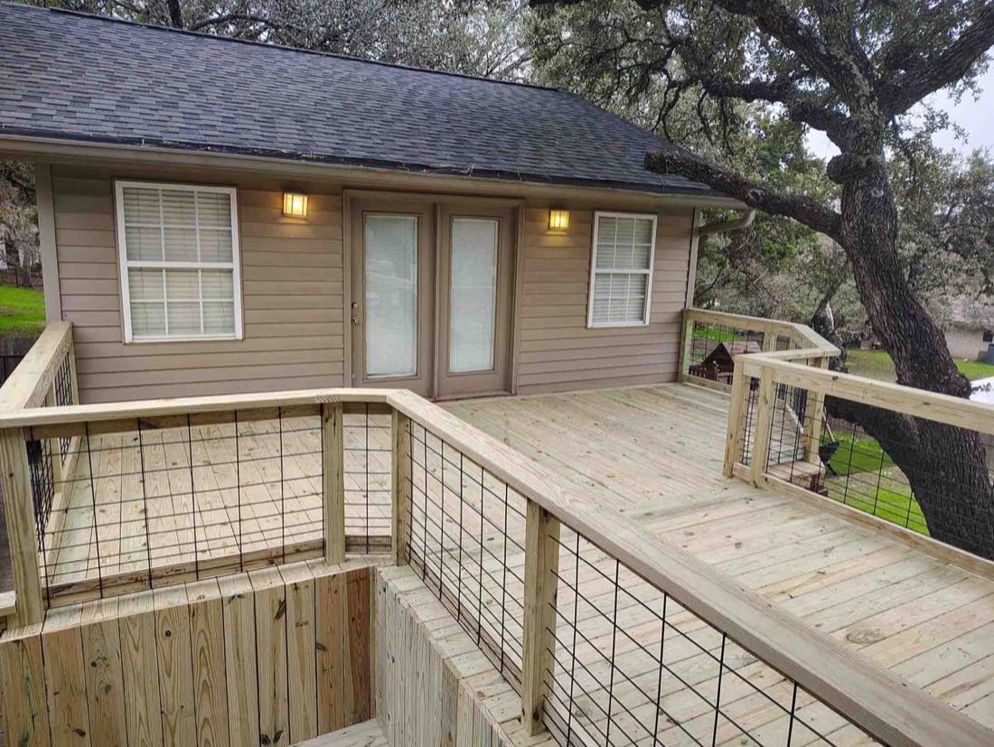 Wooden deck with house and railing