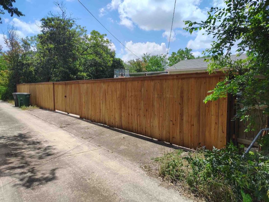 Wooden fence along a dirt path