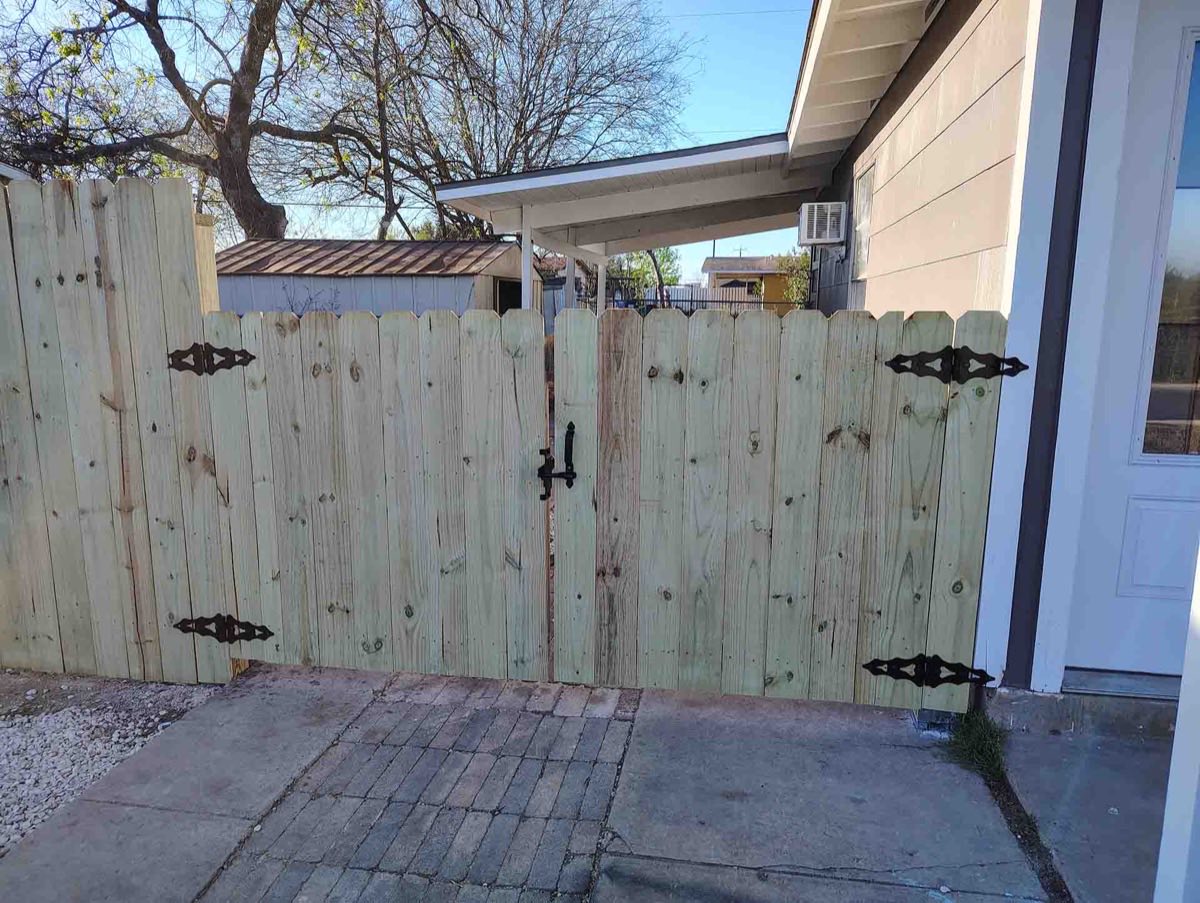 Wooden gate with decorative hinges