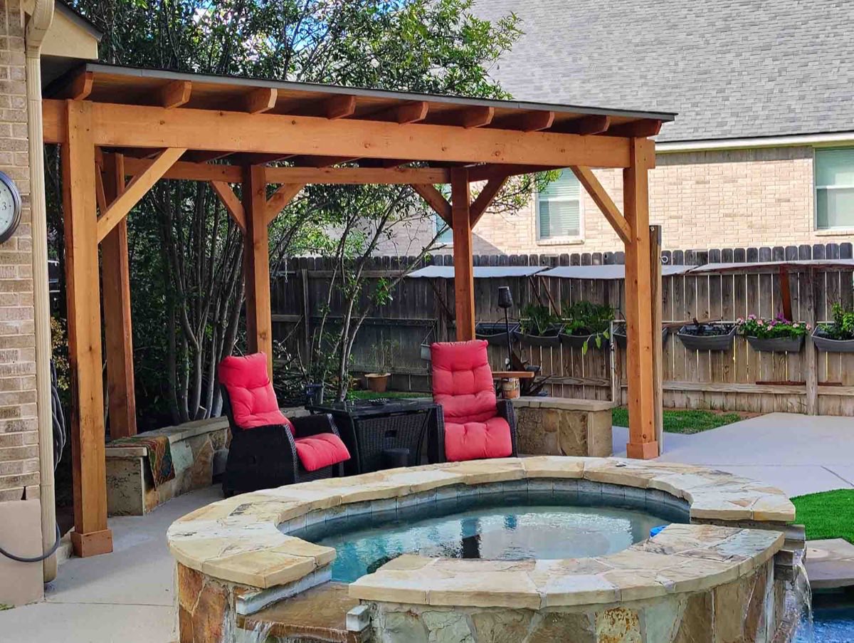 Wooden gazebo with hot tub and chairs