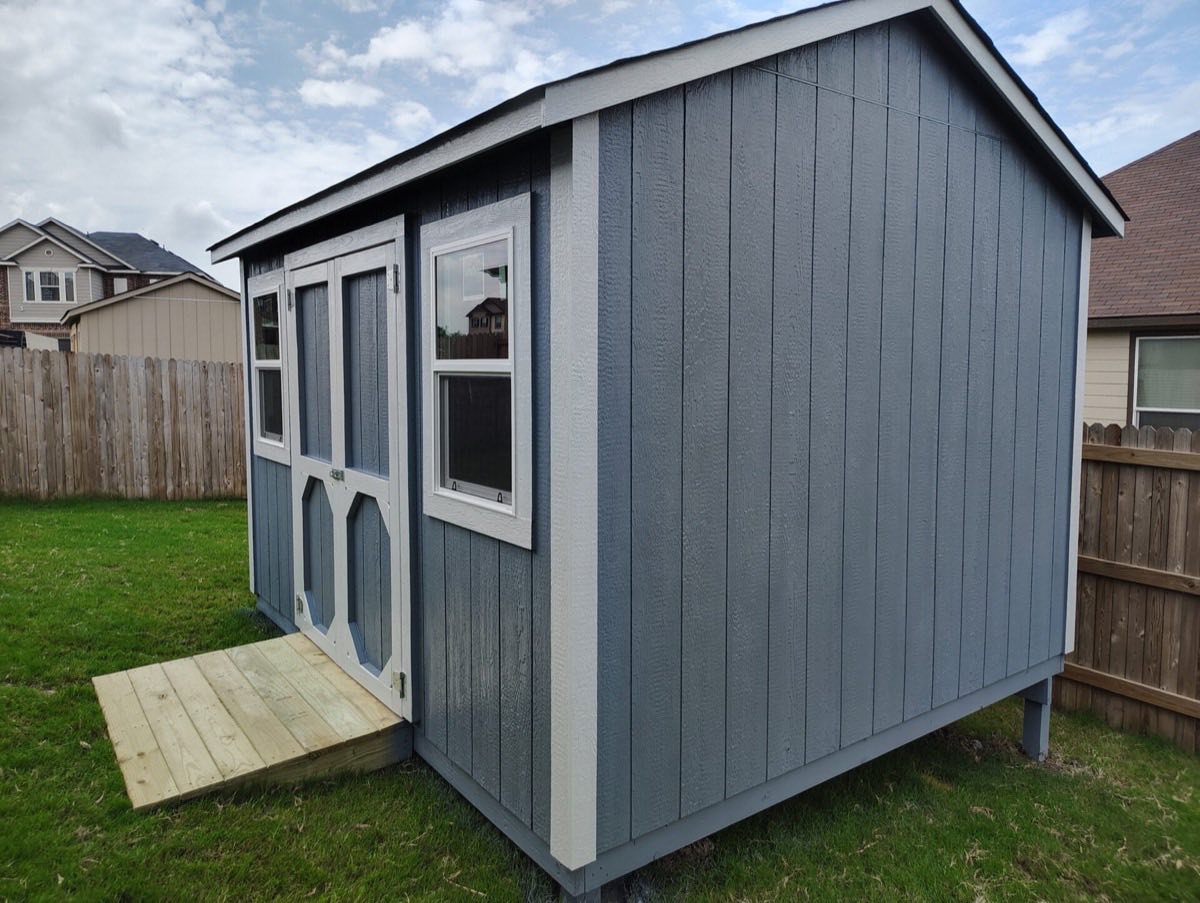 Gray shed with wooden steps outside