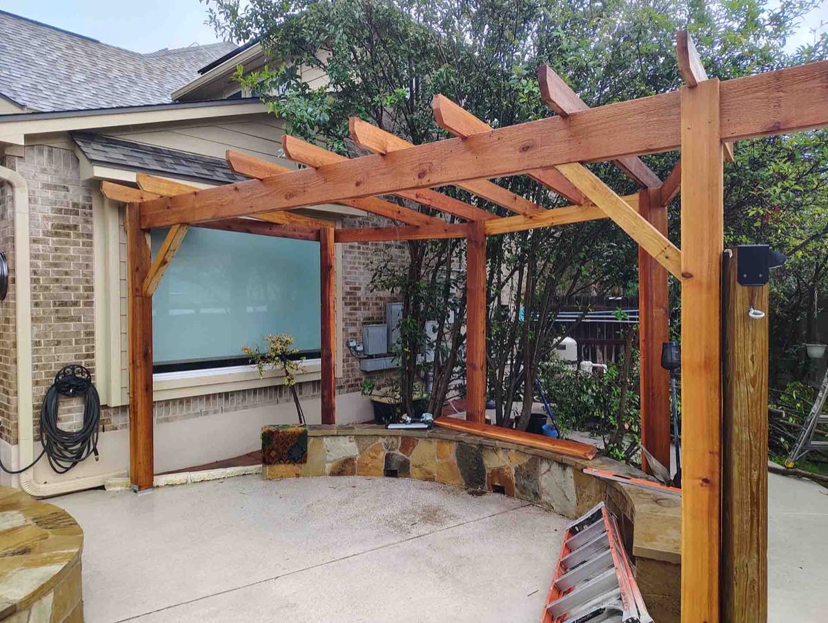 Wooden pergola with stone seating area