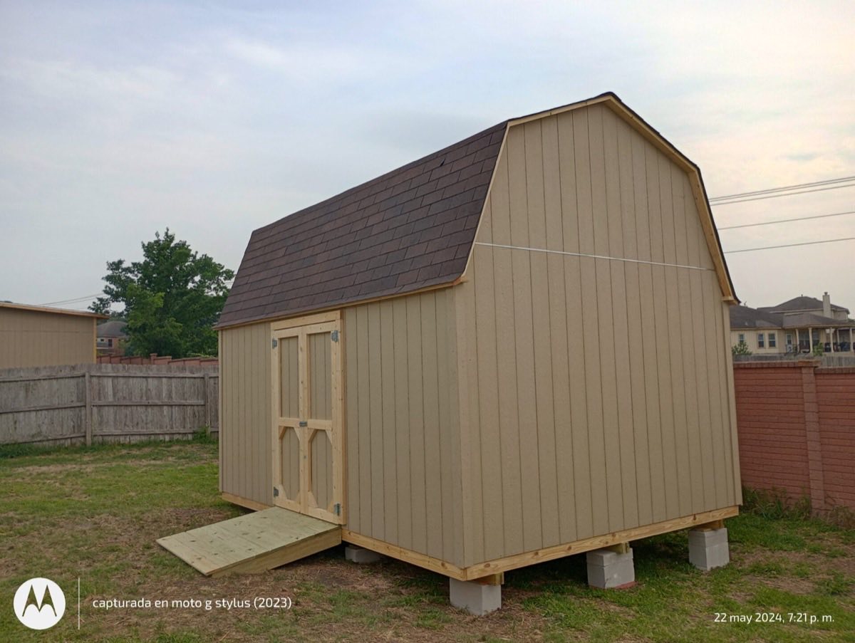 Small shed in grassy backyard
