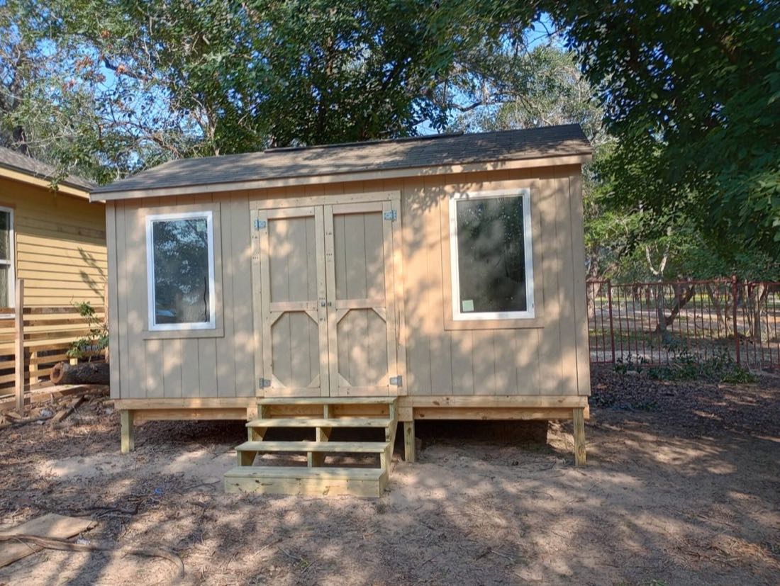 Wooden shed with steps and windows